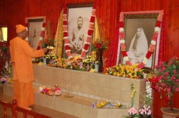Swami Smarananandaji is waving 'arati' before the Holy Trio at the altar of the Shrine as a mark of inauguration